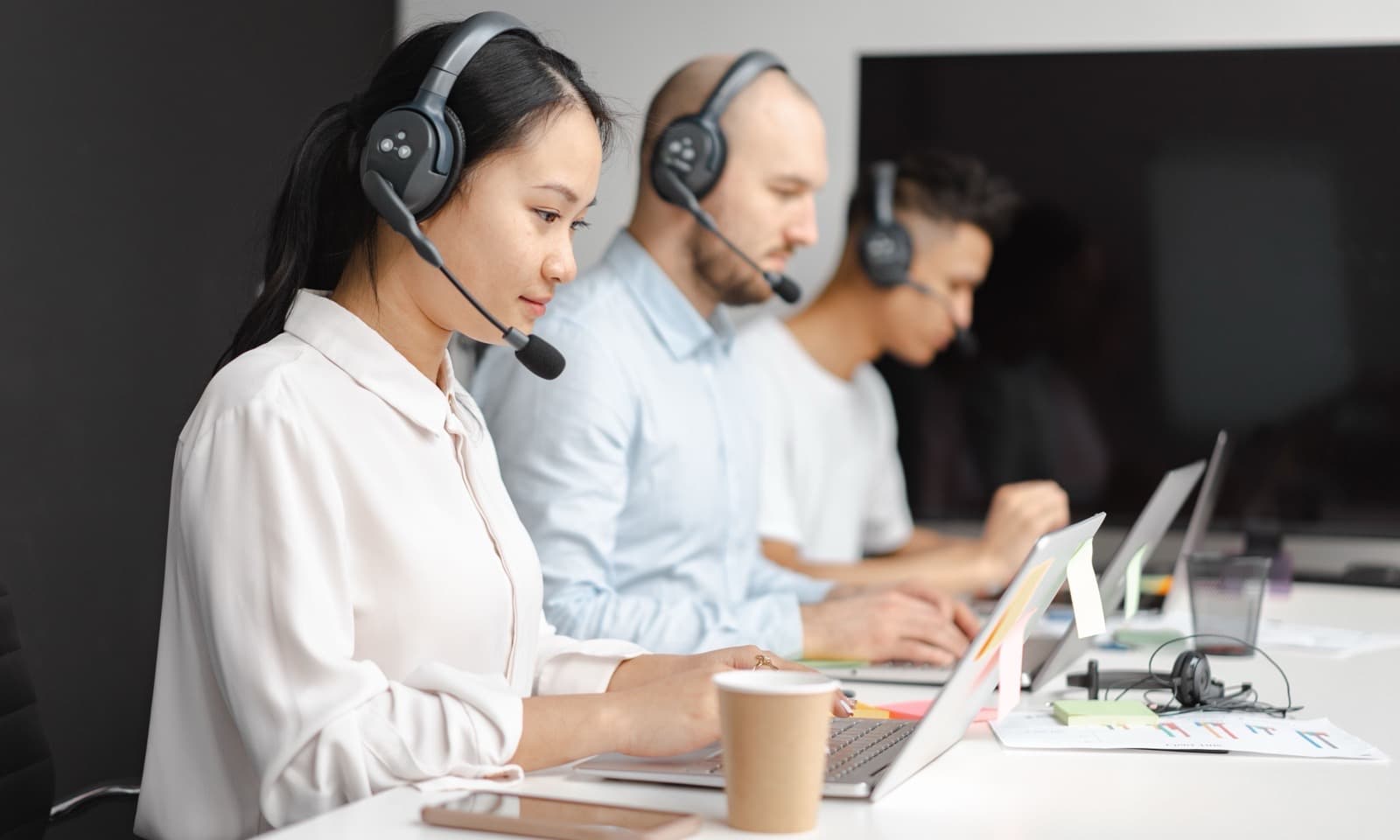 Support agent taking a call with a headset
